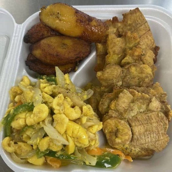 Island Flavors' Jamaican ackee and saltfish with fried plantains and breadfruit in a takeout container.